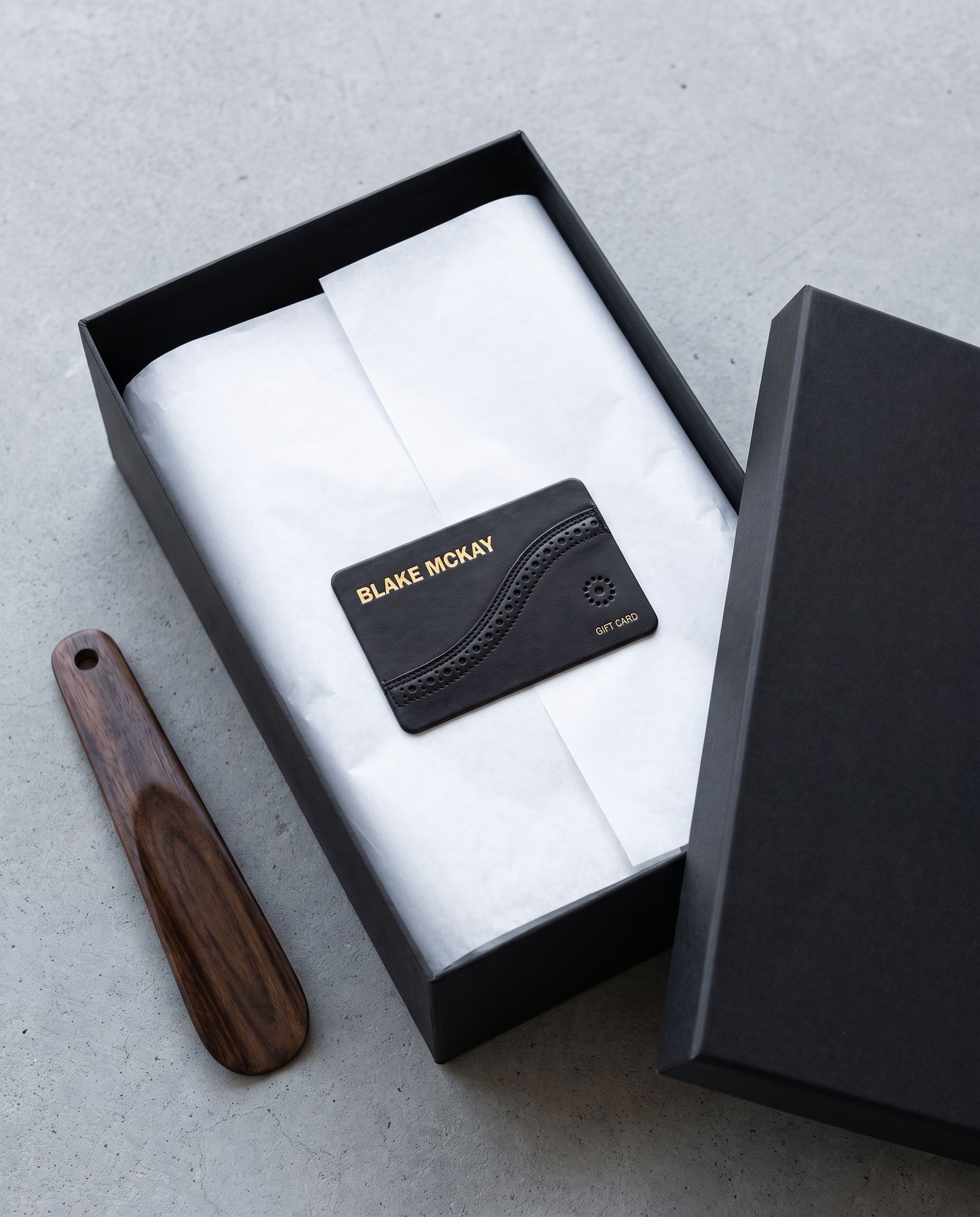 Illustration of a Blake McKay digital gift card design in an open shoebox lined with tissue